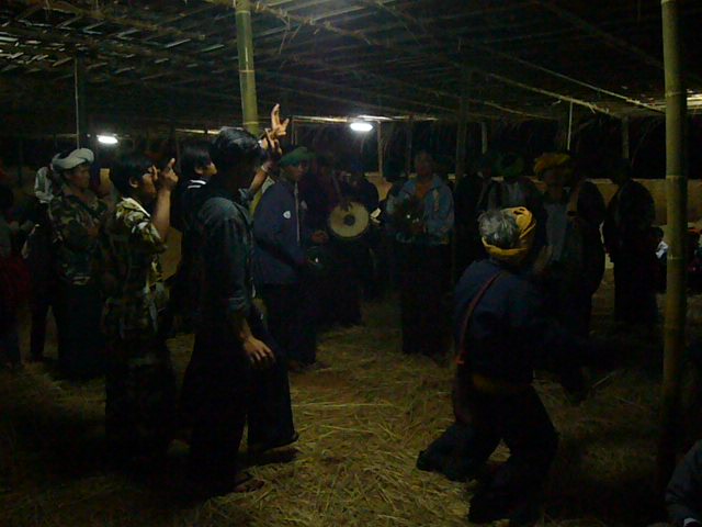 The band plays and the men dance together.